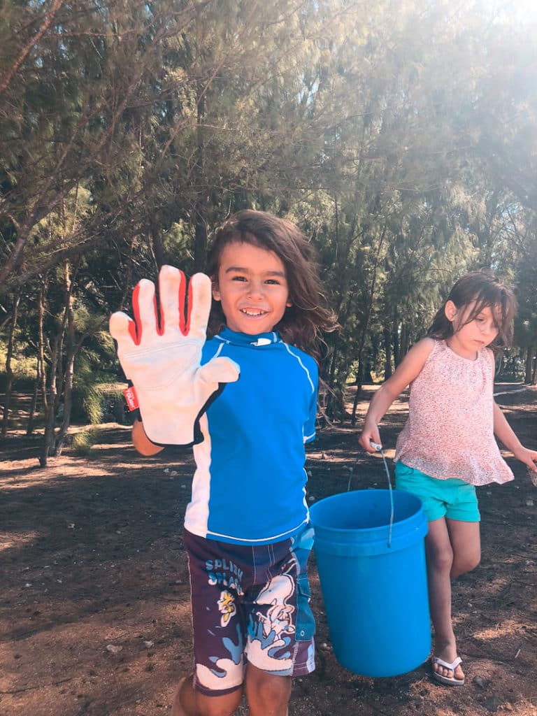 A boy participating in a beach cleanup in Hawaii. 