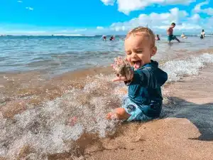 A baby playing in the water at Baby Beach in Lahaina, Maui.