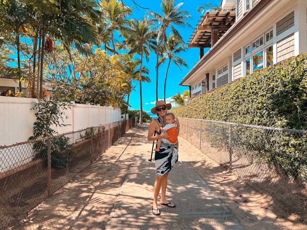 Mom and Baby smiling on pathway at Baby Beach Lahaina, Maui.