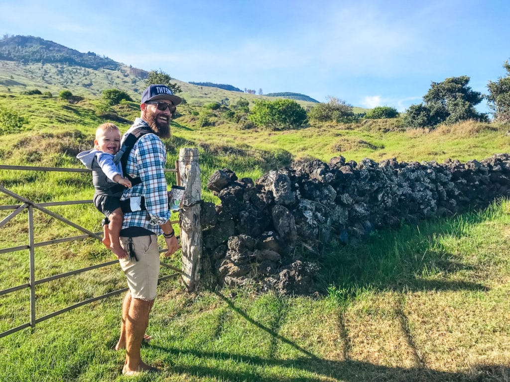 Dad wearing a baby on his back on Thompson Road, Maui, Hawaii. 