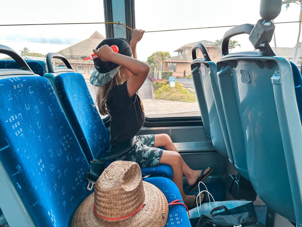 A kid requesting a stop on Maui Bus in Hawaii. 