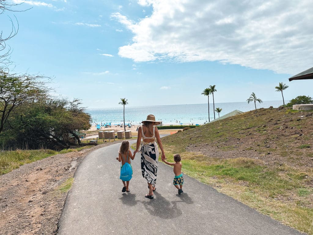 Mom walking to Hapuna Beach on the Big Island of Hawaii with kids