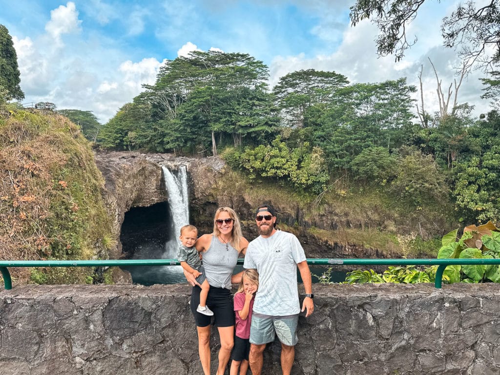 A family standing in front of Rainbow Falls in Hilo on the Big Island of Hawaii