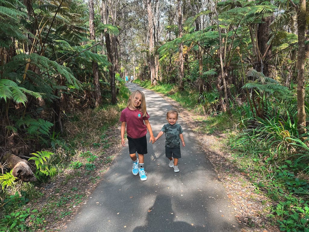 Kids holding hands on a trail at Volcanoes National Park on the Big Island of Hawaii