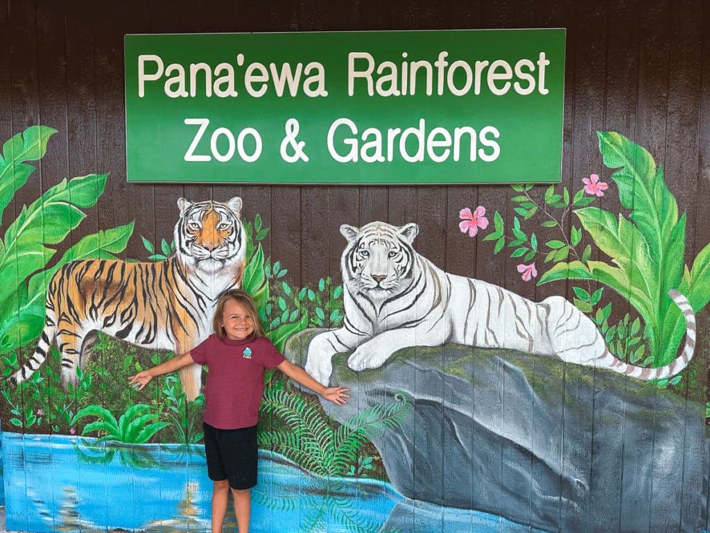 A kid standing in front of the Pana'ewa Rainforest Zoo on the Big Island of Hawaii.