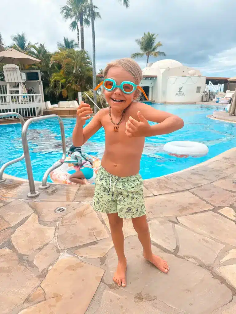 A boy wearing goggles, about to go down a water slide at Fairmont Kea Lani. 