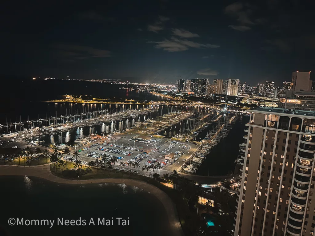 An arial view of Waikiki lit up at night time on Oahu, Hawaii. 