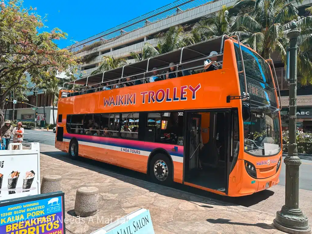 A double decker bus that reads "Waikiki Trolley" on Oahu, Hawaii. 