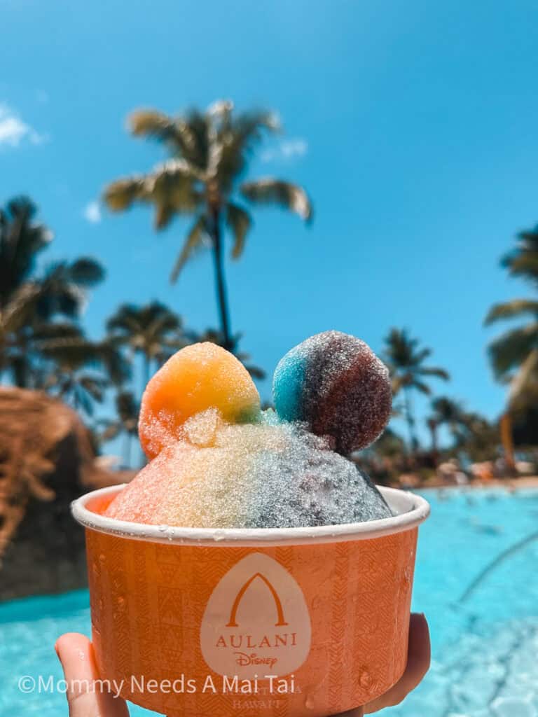 Rainbow Mickey Mouse Shave with palm trees in the background at Aulani Disney Resort on Oahu.