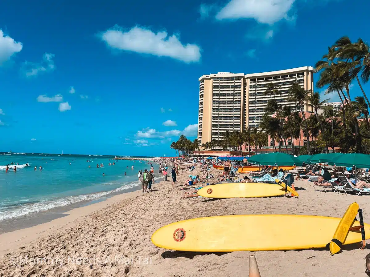 Surfboards laying on the sand on a sunny day at Waikiki Beach, Oahu.