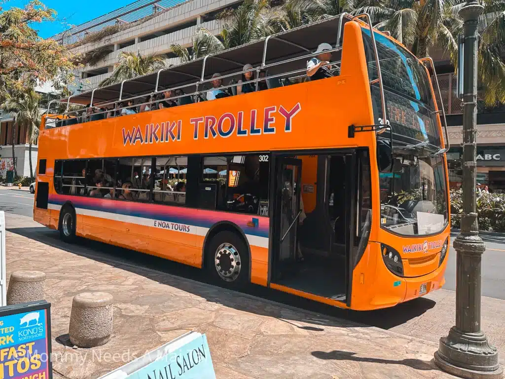 A large, double-decker Waikiki Trolley full of passengers in Waikiki, Oahu. 