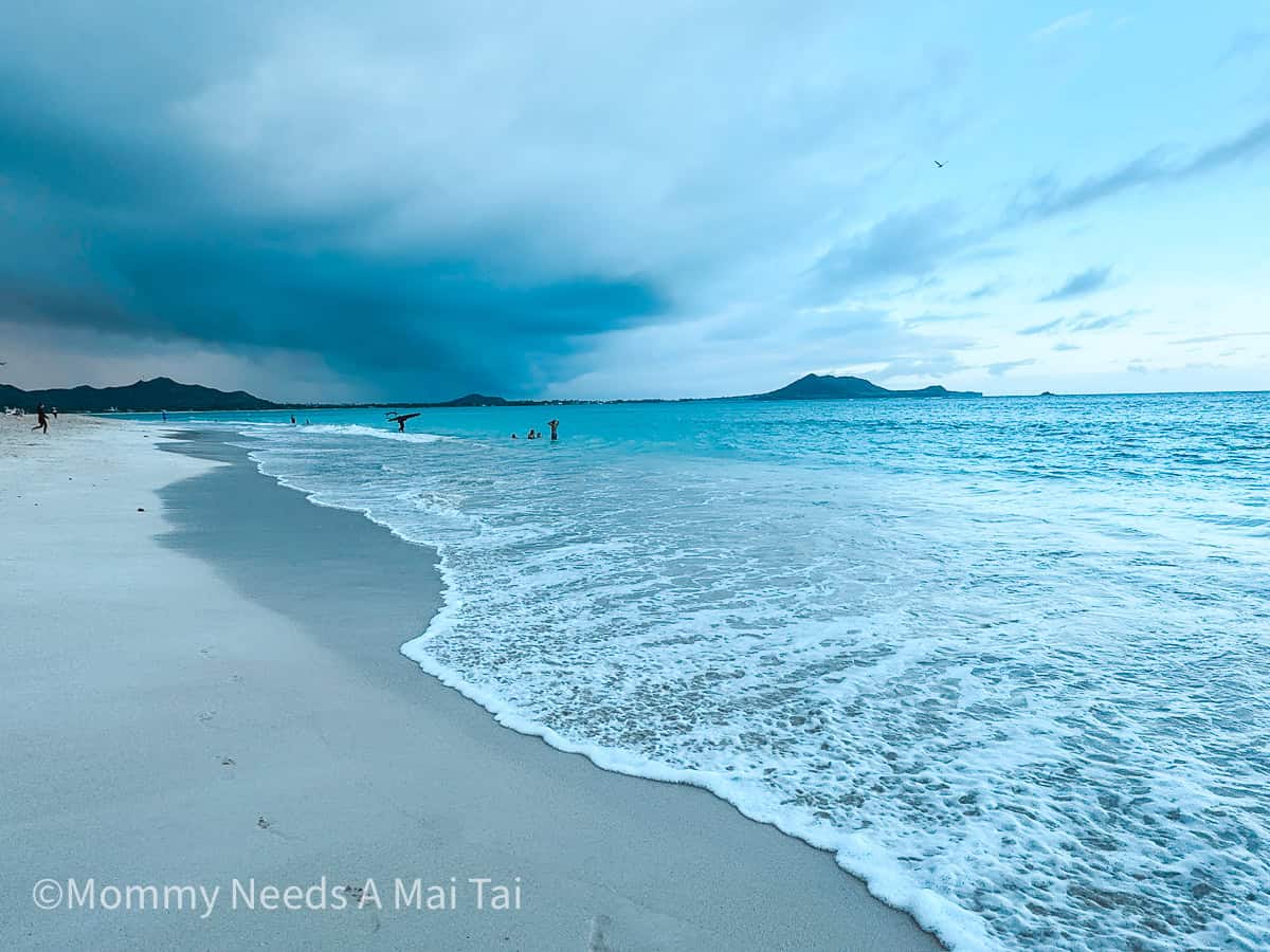 A sunset on Kailua Beach on Oahu, reflecting blue tones as the waves hit the shore.