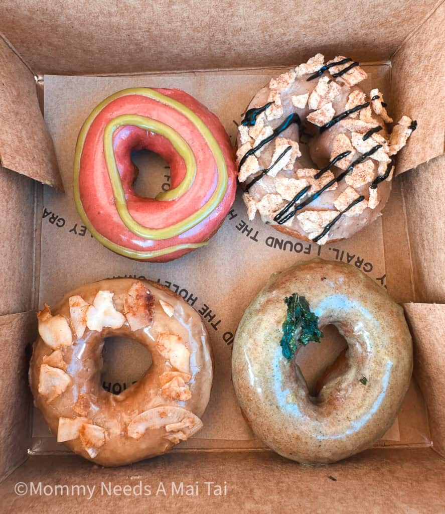 A box with four colorful donuts from Holey Grail Donuts in Kauai, Hawaii. 