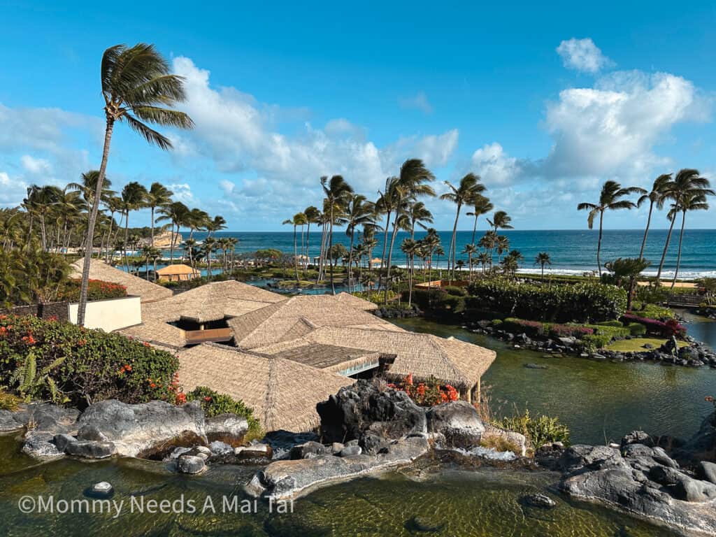 A birds eye view of Grand Hyatt Kauai Resort and Spa in Hawaii with the ocean in the background. 