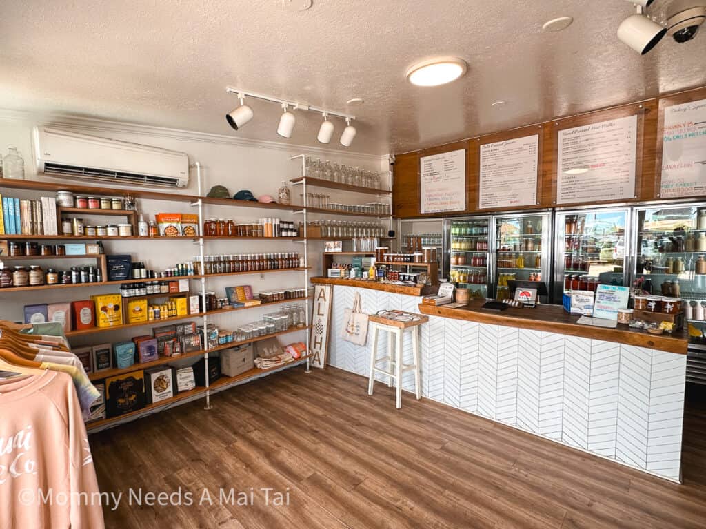 A view of the inside of Kauai Juice Co in Kapa'a, Kauai, with bright juices and merch for sale. 